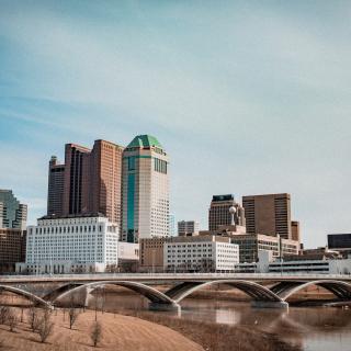 A downtown, urban cityscape under a blue sky in Columbus Ohio.