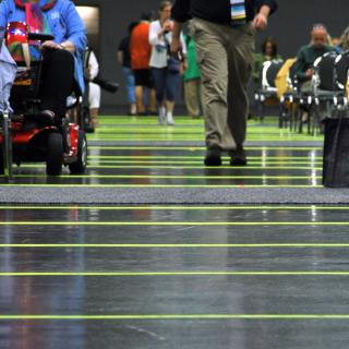 strips of yellow tape cross an aisle in the convention center