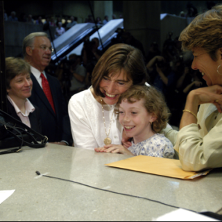 Julie and Hillary Goodridge, accompanied by their daughter, Annie, register to marry at Boston City Hall on May 17, 2004, as Mary Bonauto, their lawyer, and Mayor Thomas Menino look on.