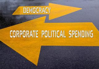 photo illustration of one arrow pointing right with "democracy" written on it and a larger arrow pointing left with "corporate political spending" written on it.